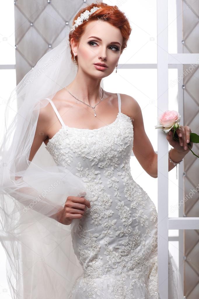 A photo of sexual beautiful bride in a wedding-dress is in fashion style. Wedding decorations