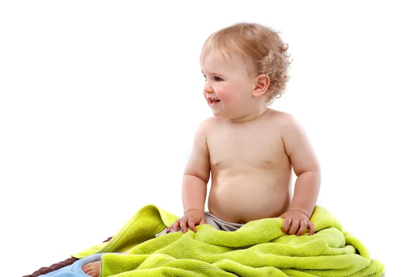 Blond baby boy on colorful towels — Stock Photo, Image