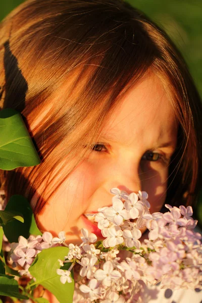 Little girl enjoying flowers — Stock Photo, Image