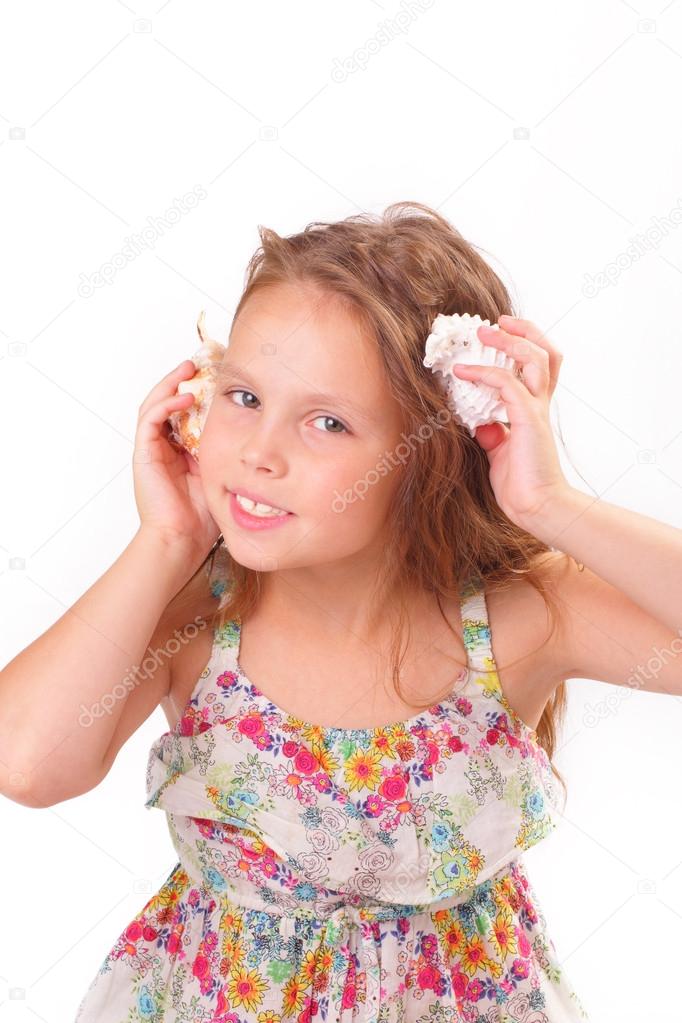 Pretty little girl with starfish and seashell