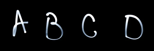 A, B, C, D - Pictured by light letters. on black — Stock Photo, Image