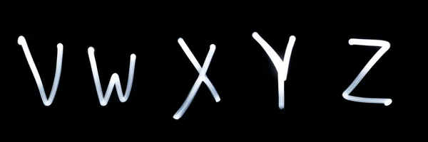 V, w, x, y, z - που απεικονίζεται από φως γράμματα. τη μαύρη — Φωτογραφία Αρχείου
