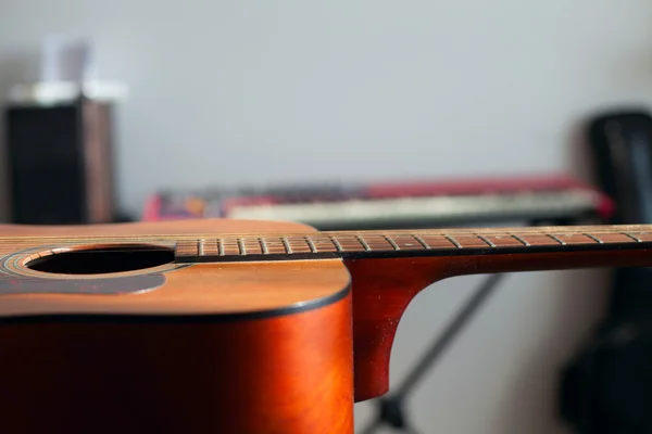 Acoustic guitar lying on the table — Stock Photo, Image