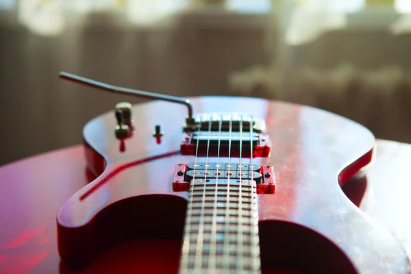 Guitarra eléctrica roja colocada sobre un terciopelo rojo. —  Fotos de Stock