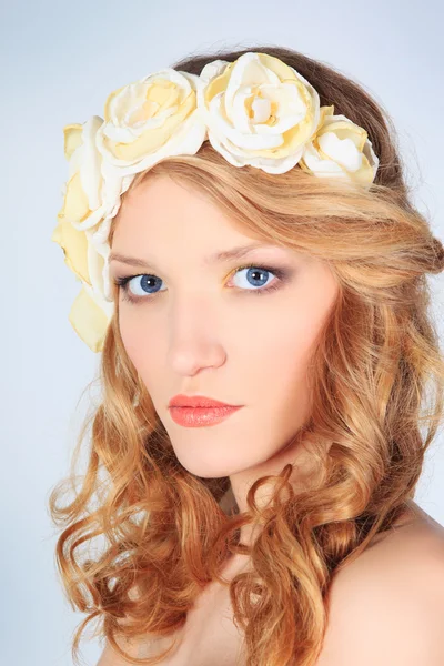 Beautiful young girl with flowers — Stock Photo, Image