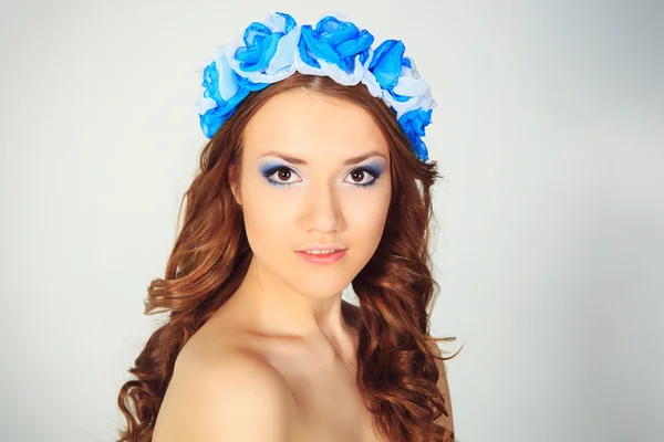 Beautiful young girl with flowers — Stock Photo, Image