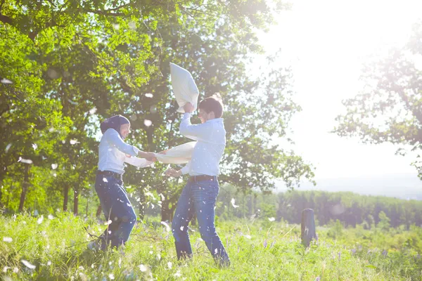 Couple having a fun pillow fight — Stock Photo, Image