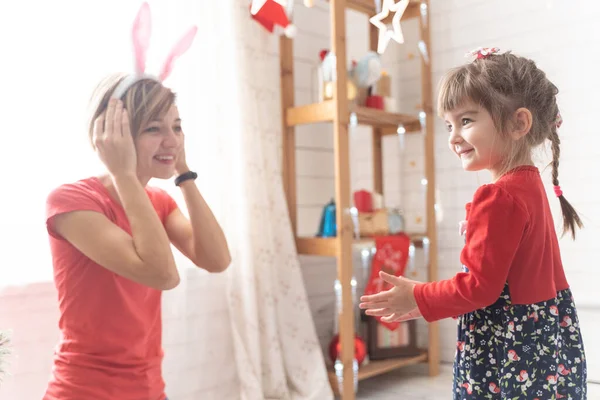 Mom and daughter dress up in a bunny costume for christmas — Stock Photo, Image