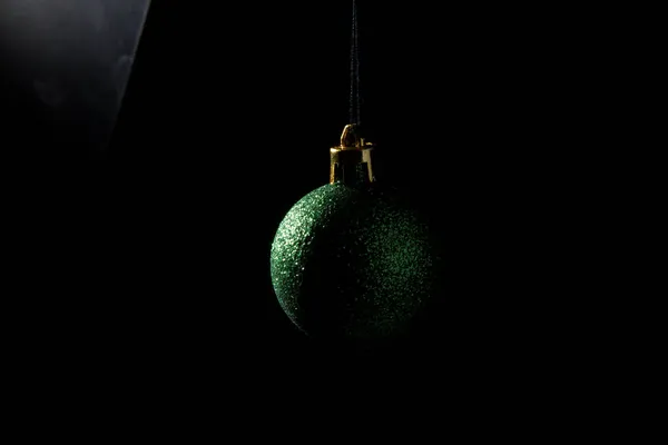 Christmas bauble over dark background. Low key photo — Stock Photo, Image