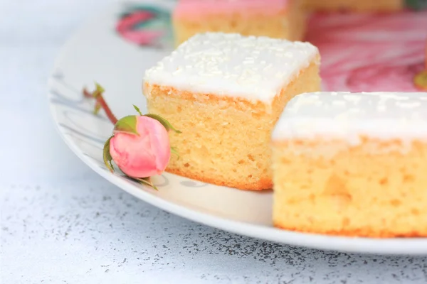 Un gâteau frais avec un bouton de rose, coupe étroite — Stock fotografie