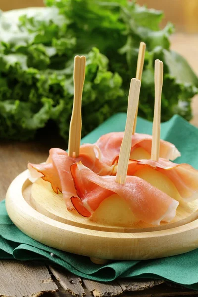 Delicious sliced ham on wooden plate — Stock Photo, Image