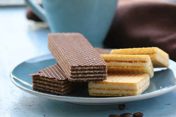 Chocolate and vanilla wafers on the blue plate — Stock Photo, Image