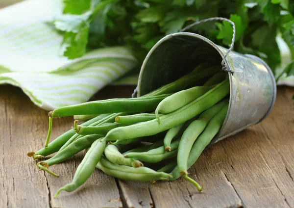 Peulen van groene erwten op een houten tafel, rustieke stijl — Stockfoto