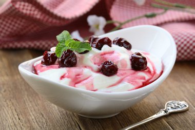 Dairy dessert with sweet sauce and cherries clipart
