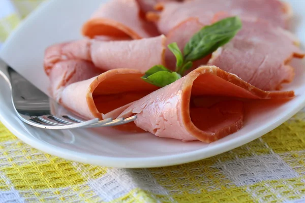 Baked sliced ham served on a white plate — Stock Photo, Image