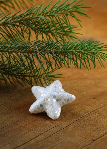 Green fir branches and christmas decorations on a wooden background — Stock Photo, Image