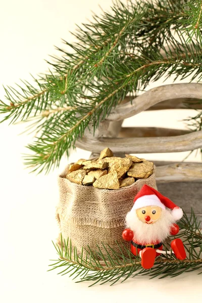 Christmas composition - bag of gifts (gold) under the green tree — Stock Photo, Image