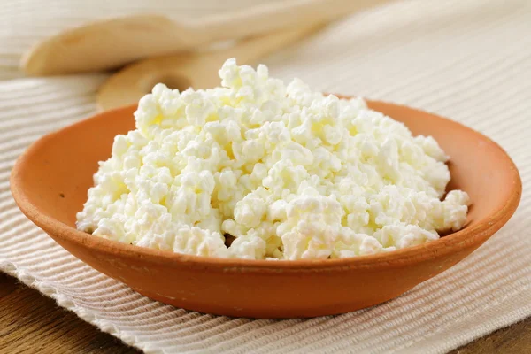 Natural dairy product cottage cheese on a wooden table, rustic style — Stock Photo, Image