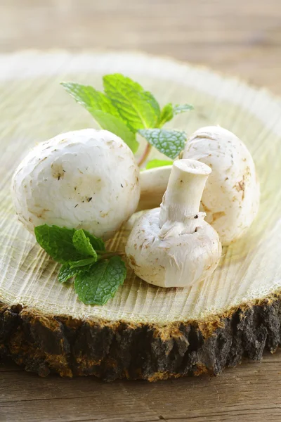 Mushrooms champignon on a wooden table — Stock Photo, Image