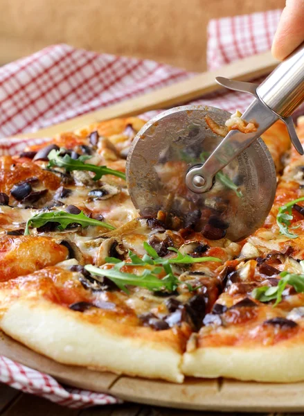 Italian pizza with mushrooms and olives on a wooden board — Stock Photo, Image