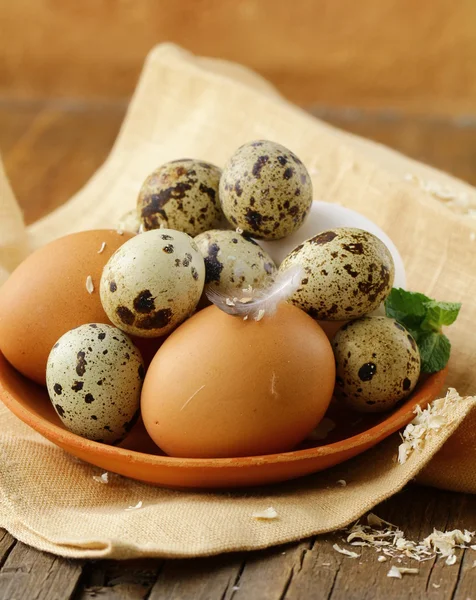 Chicken and quail eggs , rustic style — Stock Photo, Image