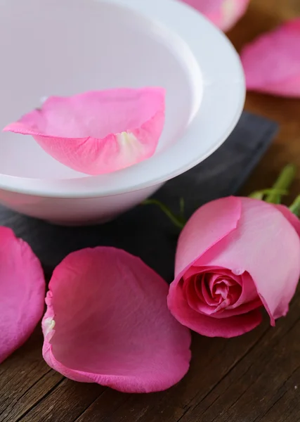 Spa concept with rose petals on a wooden background — Stock Photo, Image