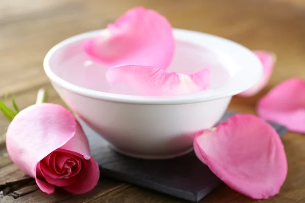 Spa concept with rose petals on a wooden background — Stock Photo, Image