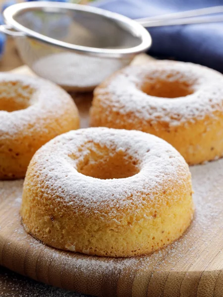 Fresh donuts sprinkled with powdered sugar — Stock Photo, Image