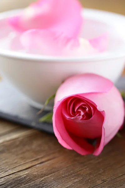 Spa concept with rose petals on a wooden background — Stock Photo, Image