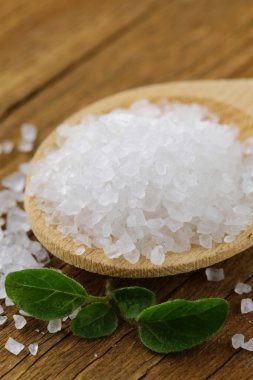 Large sea salt on a wooden background clipart