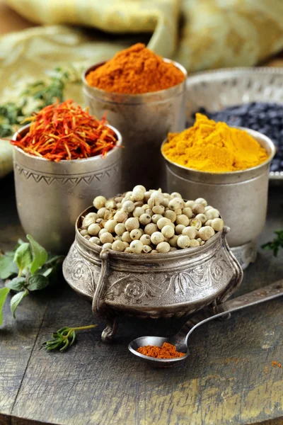 Various spices (turmeric, paprika, saffron, coriander) in metal bowls — Stock Photo, Image