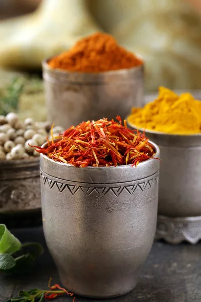 Various spices (curcuma, paprika, saffron, coriander) in metal bowls — Stock Photo, Image