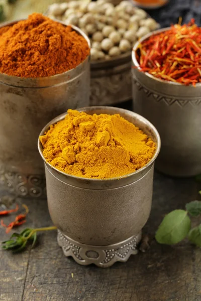 Various spices (curcuma, paprika, saffron) in metal bowls — Stock Photo, Image