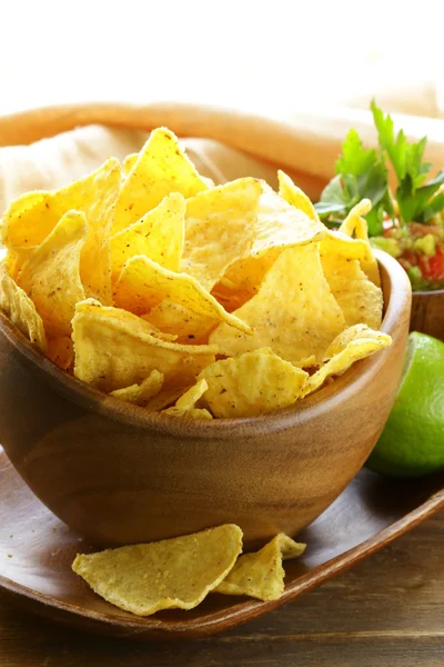 Corn tortilla chips in a wooden bowl — Stock Photo, Image