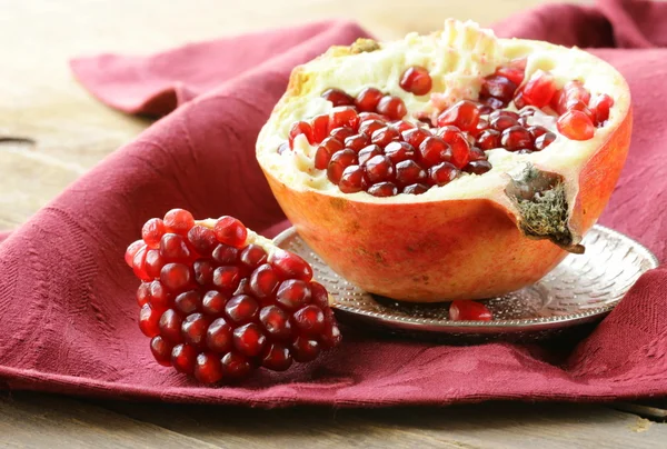 Pomegranate ripe fruit on a silver plate — Stock Photo, Image