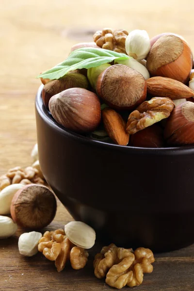 Mix nuts - walnuts, hazelnuts, almonds on a wooden table — Stock Photo, Image