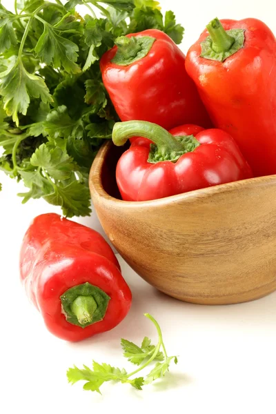 Fresh ripe red bell paprika peppers and parsley — Stock Photo, Image