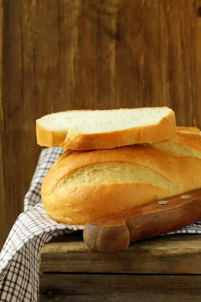 Loaf of white bread on a wooden table — Stock Photo, Image