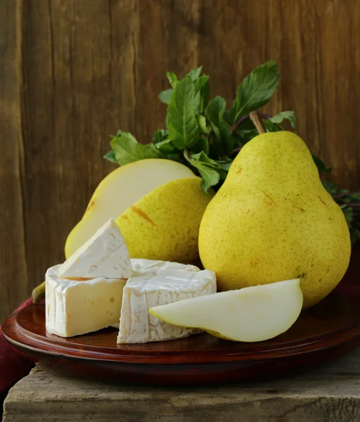 Piece of soft cheese with and pears (brie, camembert) — Stock Photo, Image