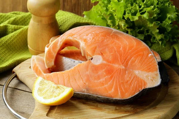 Fresh raw red fish (salmon) on a cutting board Stock Image