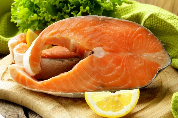 Fresh raw red fish (salmon) on a cutting board Stock Photo