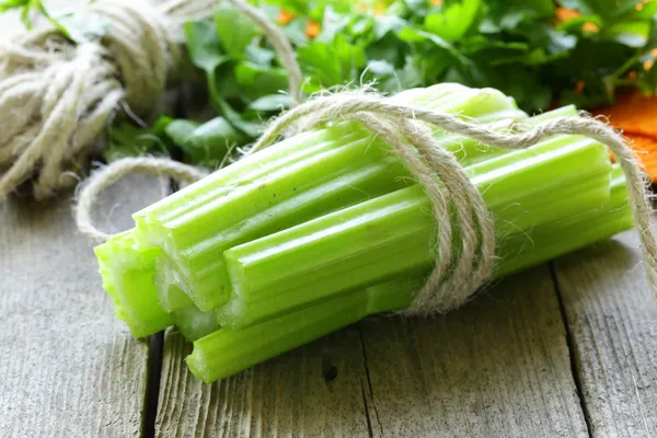 Fresh celery sticks on a wooden table, rustic style — Stock Photo, Image