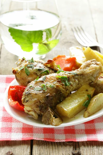 Baked chicken legs with vegetables for garnish — Stock Photo, Image