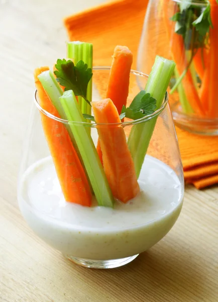 Carrots and celery with dip in a glass beakers — Stock Photo, Image