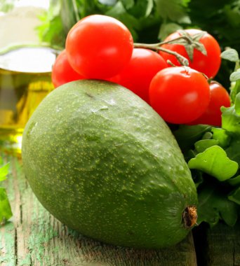 Natürmort otlar ve taze sebzeler (avokado, domates) zeytinyağı
