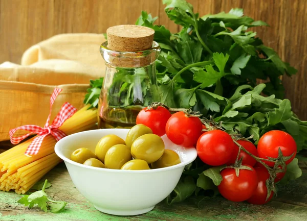 Still life of olives, herbs, cherry tomatoes and Italian pasta — Stock Photo, Image