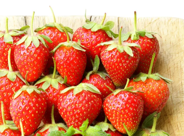 Lots of fresh ripe strawberries on a wooden board — Stock Photo, Image