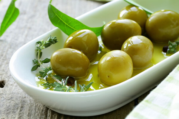 Green olives with fragrant oil and spices