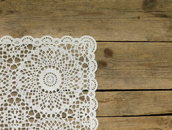 Wooden background with white lace napkin — Stock Photo, Image