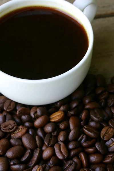 Cup of espresso coffee on a background coffee beans — Stock Photo, Image